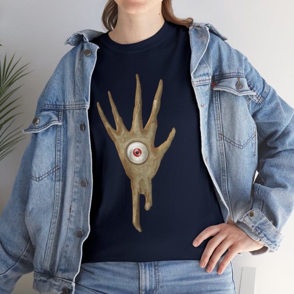 The symbol of Vecna, a hand with an eye in the palm, on a navy blue shirt under a jean jacket