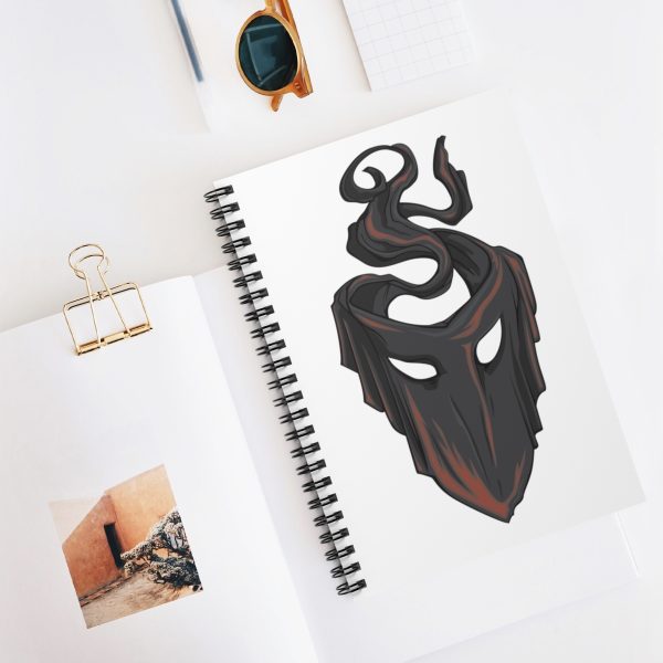 The symbol of mask, a black velvet mask, on a notebook, desktop