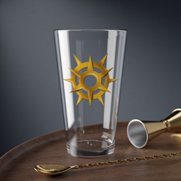 16 oz pint glass with the dnd symbol of Pelor, fantasy deity of dungeons and dragons, on desk