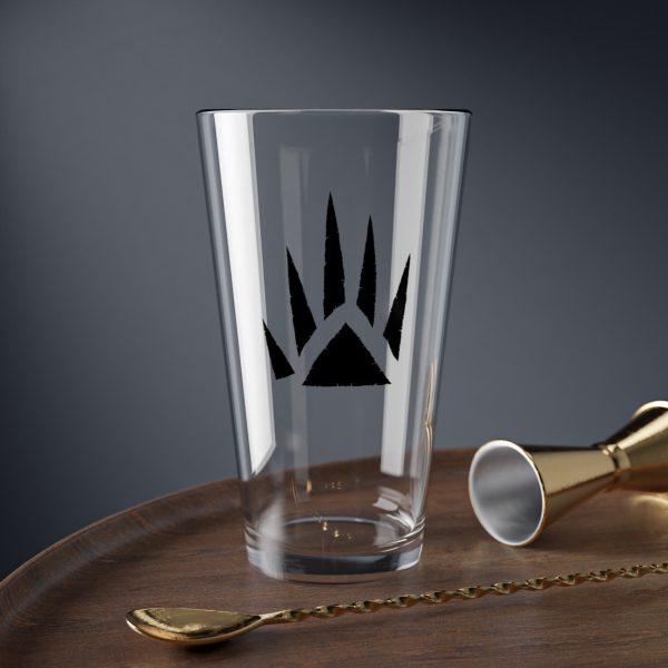 16 oz pint glass with the dnd symbol of Bane, fantasy deity of dungeons and dragons, on desk