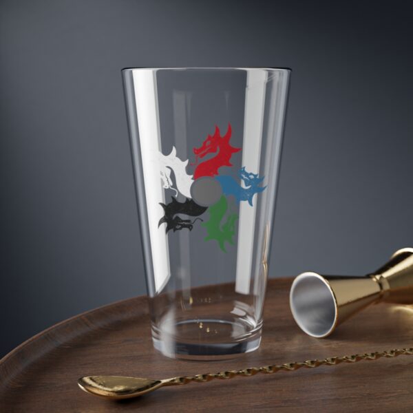 16 oz pint glass with the dnd symbol of tiamat, fantasy deity of dungeons and dragons, on desk