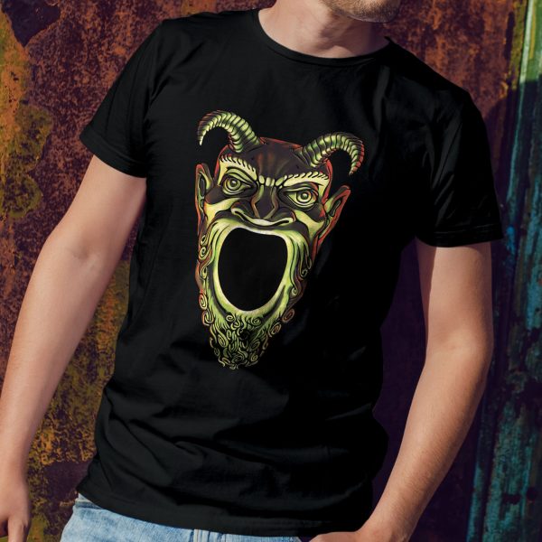 A shirt with the symbol of Acererak, the face of a demon with a gaping maw, a favorite DnD villain, on a black shirt worn by a man leaning against a wall
