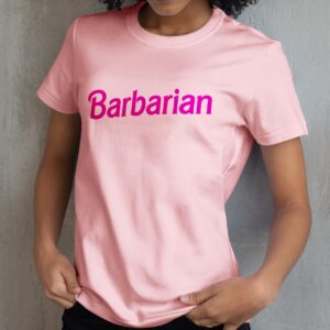 A barbie barbarian shirt, fun dungeons and dragons shirts, pink and worn by a woman angled