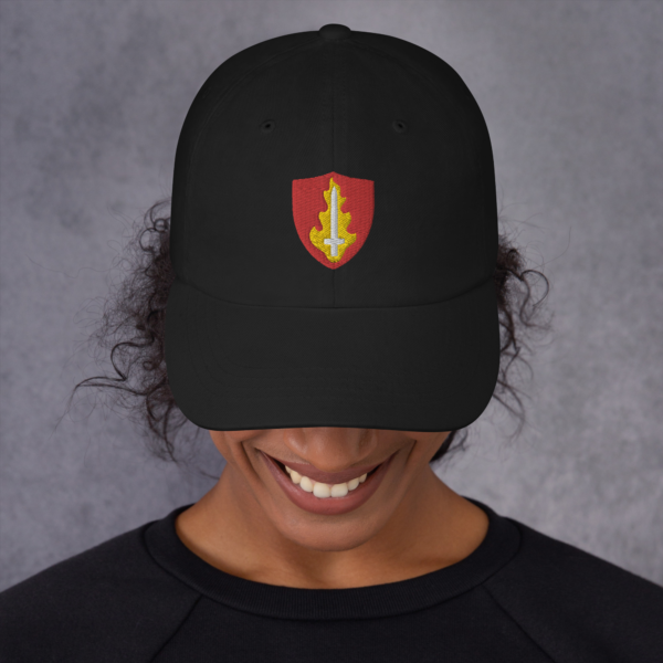 A hat with the symbol of Tempus, an upright flaming sword. The god of war in DnD. Black Hat worn by woman looking down/