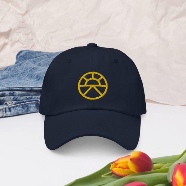 The symbol of Lathander, the DnD deity of renewal, a rising sun, on a navy blue hat
