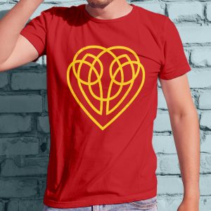 The symbol of Hanali Celanil, a gold heart, on a red shirt worn by a man standing against a wall