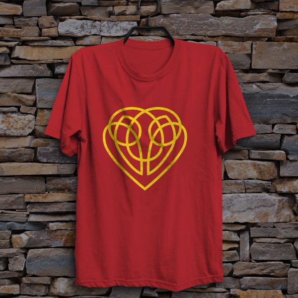 The symbol of Hanali Celanil, a gold heart, on a red shirt hanging on a wall