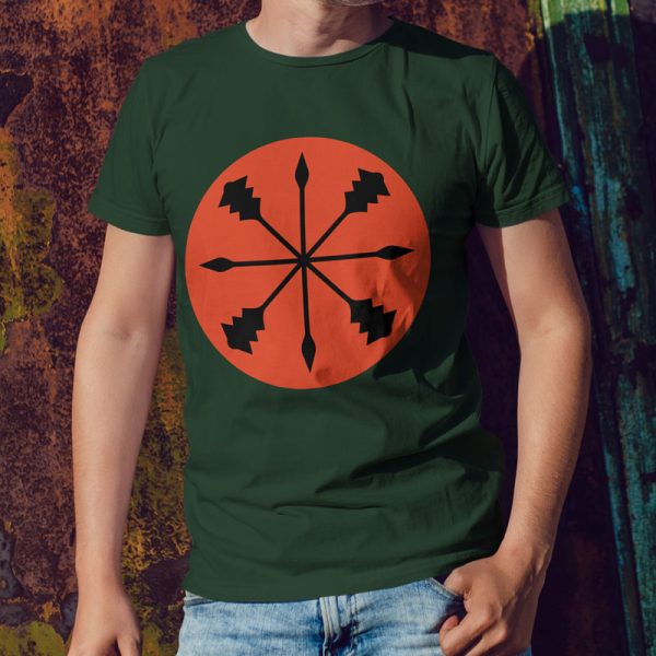 Forest green t-shirt with the symbol of kord, a star of spears and maces, worn by a man leaning against a wall
