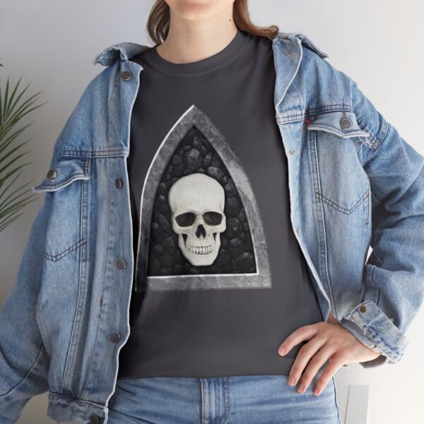 The symbol of Myrkul, a white human skull on a black field, on a charcoal gray shirt under a jacket