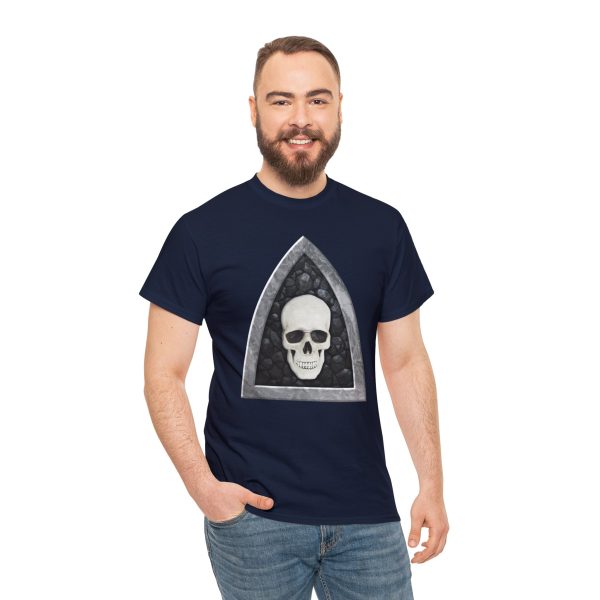 The symbol of Myrkul, a white human skull on a black field, on a navy blue shirt worn by a man