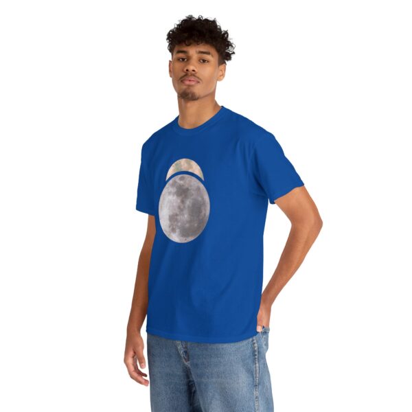 The symbol of Sehanine Moonbow, a misty crescent above a full moon, on a royal blue shirt worn by a man