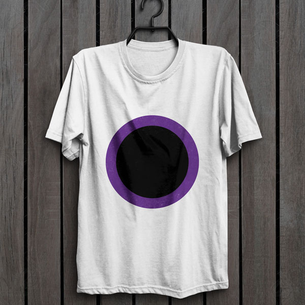 Black disk surrounded by a purple border, the symbol of Shar, on a white t-shirt hanging on a wall