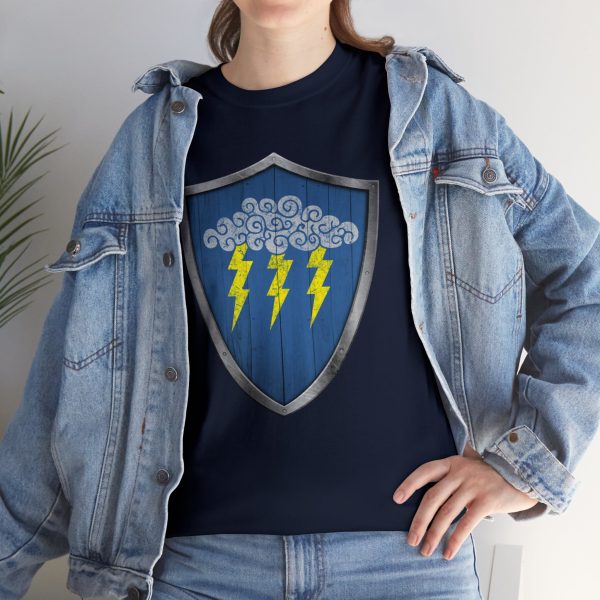 The DnD symbol of Valkur, a cloud with three lightning bolts on a shield, on a navy blue shirt under a jean jacket