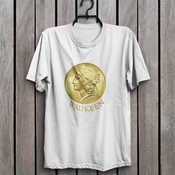 The DnD symbol of Waukeen, an upright coin with Waukeen’s profile facing left, on a white shirt hanging on a wall