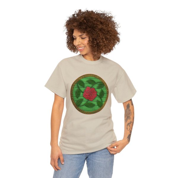 The symbol of Chauntea on a shield, a blooming rose on a sunburst wreath of golden grain. Chauntea is the goddess of life and agriculture. On sand tan shirt worn by a woman