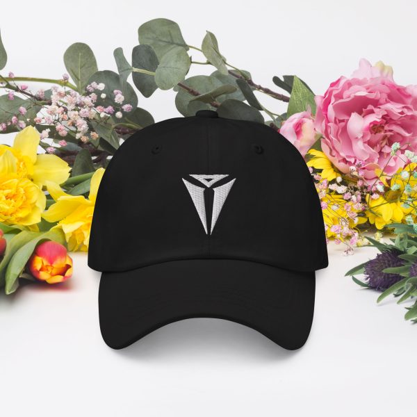 A black DnD hat with the symbol of Asmodeus, Archdevil and the Prince of Hell. On a table with flowers.