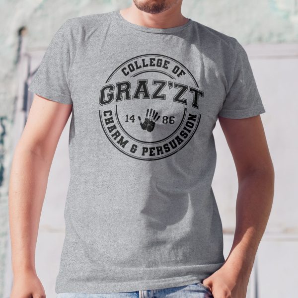 A fun collegiate shirt for Grazzt's College of Charm and Persuation - Grazzt is a gorgeous demon lord that rule through charm and manipulation; a famous DnD villain. This is a sport gray shirt worn by a man against a wall