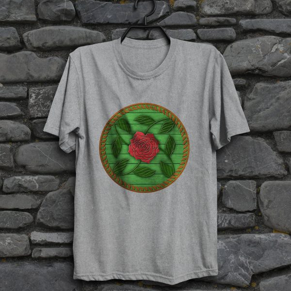 The symbol of Chauntea on a shield, a blooming rose on a sunburst wreath of golden grain. Chauntea is the goddess of life and agriculture. On a sport gray shirt hanging on a wall.