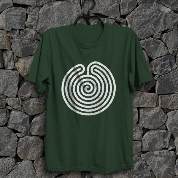 The symbol of Ubtao, a circular maze, on a forest green shirt hanging on a wall. The Chult deity in DnD.