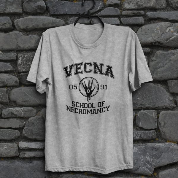 A weathered sport gray shirt with the Vecna School of Necromancy, hanging on a wall
